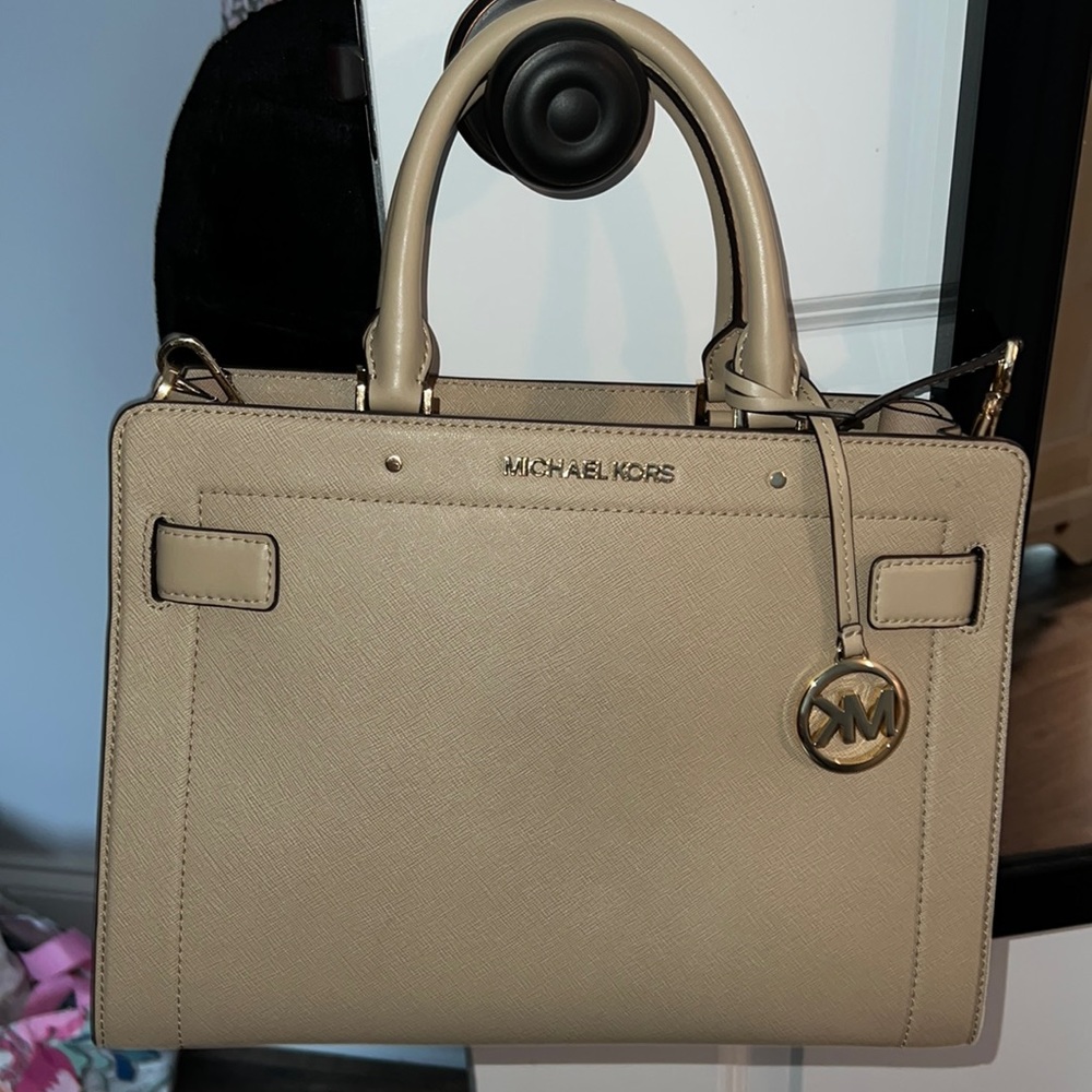 Michael Kors medium sized bag. Tan with gold hardware. Comes with long strap.